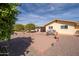 View of the house from the backyard featuring citrus trees and desert landscaping at 10511 W Edgewood Dr, Sun City, AZ 85351