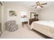 This bedroom has carpet floors, a ceiling fan and chair at 10511 W Edgewood Dr, Sun City, AZ 85351