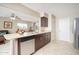 Open-concept kitchen with stainless steel appliances and granite countertops flows into the living area at 10511 W Edgewood Dr, Sun City, AZ 85351