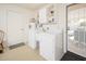 This laundry room has a washer, dryer, sink and cabinets at 10511 W Edgewood Dr, Sun City, AZ 85351