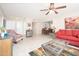 Bright living room with a ceiling fan, stylish furniture, and an open dining area at 10511 W Edgewood Dr, Sun City, AZ 85351