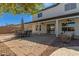 Charming backyard with a covered patio and dining set, perfect for outdoor entertaining and relaxation at 10616 E Carol Ave, Mesa, AZ 85208