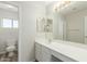 Bathroom featuring white vanity, large mirror with vanity lights, and modern sink at 10616 E Carol Ave, Mesa, AZ 85208