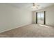 Bedroom with a large window and carpet flooring. The space is bright and airy at 10616 E Carol Ave, Mesa, AZ 85208