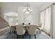 Dining area with hardwood floors, and modern lighting fixtures. Table is set for six guests at 10616 E Carol Ave, Mesa, AZ 85208