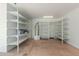 Organized garage space featuring built-in shelving units for ample storage and efficient organization at 10616 E Carol Ave, Mesa, AZ 85208