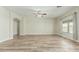 Spacious living room featuring an arched entryway, wood floors and a large window with backyard views at 10616 E Carol Ave, Mesa, AZ 85208