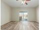 Bright living room with wood floors and sliding glass doors to the backyard pool at 10616 E Carol Ave, Mesa, AZ 85208