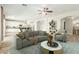 Living room featuring wood floors, modern furniture, an open-concept layout and connections to kitchen, bathroom and stairs at 10616 E Carol Ave, Mesa, AZ 85208