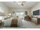 Stylishly furnished main bedroom with a ceiling fan and sliding glass doors overlooking the backyard pool at 10616 E Carol Ave, Mesa, AZ 85208