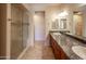 Bathroom showcases dual sinks, granite counters, custom cabinetry, and large glass shower at 11011 N Zephyr Dr # 106, Fountain Hills, AZ 85268