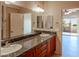 Bathroom features dual sinks with granite counters and custom wood cabinetry at 11011 N Zephyr Dr # 106, Fountain Hills, AZ 85268