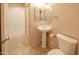 Bathroom featuring a pedestal sink, oval mirror, tile flooring and private toilet at 11011 N Zephyr Dr # 106, Fountain Hills, AZ 85268