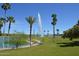 Scenic lake with a tall fountain surrounded by lush green lawns and palm trees at 11011 N Zephyr Dr # 106, Fountain Hills, AZ 85268