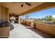 Covered patio with ceiling fans, a full outdoor kitchen, a grill, and serene desert views at 11011 N Zephyr Dr # 106, Fountain Hills, AZ 85268