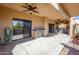 A large covered patio with an outdoor kitchen, sink, ceiling fans, and a desert view at 11011 N Zephyr Dr # 106, Fountain Hills, AZ 85268