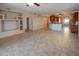 Open concept living area with tile flooring, a kitchen view and built-in shelving at 11011 N Zephyr Dr # 106, Fountain Hills, AZ 85268