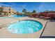 Hot tub and pool surrounded by lounge chairs and meticulously maintained landscaping at 11011 N Zephyr Dr # 106, Fountain Hills, AZ 85268