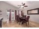 An elegant dining room with a ceiling fan, dining table, and sliding glass doors at 11178 W Echo Ln, Peoria, AZ 85345