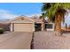 Charming single-story home with a two car garage, desert landscaping and a mature palm tree at 11178 W Echo Ln, Peoria, AZ 85345