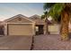 Charming single-story home with a two car garage, desert landscaping and a mature palm tree at 11178 W Echo Ln, Peoria, AZ 85345