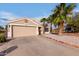 Charming single-story home with a two car garage, desert landscaping and mature palm trees at 11178 W Echo Ln, Peoria, AZ 85345