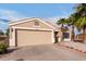 Charming single-story home with a two car garage, desert landscaping and mature palm trees at 11178 W Echo Ln, Peoria, AZ 85345