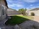 A grassy backyard featuring desert landscaping, concrete block wall, and a lawn at 11946 W Jackson St, Avondale, AZ 85323