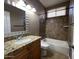 Tiled bathroom features granite countertop and tiled shower-tub combo at 11946 W Jackson St, Avondale, AZ 85323