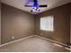 Standard bedroom features neutral paint, ceiling fan, and tile floors at 11946 W Jackson St, Avondale, AZ 85323