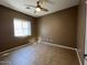 Standard bedroom features neutral paint, ceiling fan, and tile floors at 11946 W Jackson St, Avondale, AZ 85323