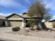 Charming single-story home with well-maintained landscaping and covered entry at 11946 W Jackson St, Avondale, AZ 85323