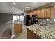 Open concept kitchen featuring stainless steel appliances, granite counters, and lots of light at 11946 W Jackson St, Avondale, AZ 85323