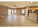 Open concept living area featuring tile floors, access to back yard, and views of the kitchen at 11946 W Jackson St, Avondale, AZ 85323