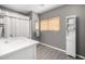 Bathroom featuring wood-look floors, gray walls, white vanity, cabinet, a framed mirror, and window at 1202 E Milada Dr, Phoenix, AZ 85042