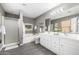 Bright bathroom features a double sink vanity, soaking tub, and a glass-enclosed shower at 1202 E Milada Dr, Phoenix, AZ 85042