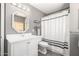 Bathroom with decorative framed mirror, gray walls, and white vanity and toilet at 1202 E Milada Dr, Phoenix, AZ 85042