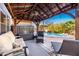 Inviting covered patio featuring a comfortable seating area, a ceiling fan, and views of the pool at 1202 E Milada Dr, Phoenix, AZ 85042