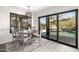 Bright dining area features a modern light fixture and sliding glass doors leading to the pool at 1202 E Milada Dr, Phoenix, AZ 85042