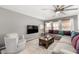 Comfortable living room features a large sectional sofa and modern ceiling fan at 1202 E Milada Dr, Phoenix, AZ 85042