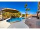 Backyard pool with palm trees, rock waterfall, and a lush tropical landscaping at 1202 E Milada Dr, Phoenix, AZ 85042