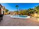 Sparkling backyard pool, a built-in waterfall feature, and a spacious brick-paved patio, perfect for outdoor living at 1202 E Milada Dr, Phoenix, AZ 85042