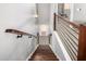 Modern staircase with wood and metal railings leading to a bright, open space at 1202 E Milada Dr, Phoenix, AZ 85042