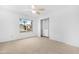 Bedroom with plush carpeting, ceiling fan, and built-in closet shelves at 12215 S Potomac St, Phoenix, AZ 85044