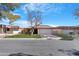 Charming single-story home with a tile roof, green lawn, and a two-car garage at 12215 S Potomac St, Phoenix, AZ 85044