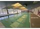 Bright indoor swimming pool featuring lots of natural light, geometric tiling and lane lines at 12215 S Potomac St, Phoenix, AZ 85044