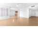 Bright living room with wood-look floors, white walls and view to kitchen at 12215 S Potomac St, Phoenix, AZ 85044