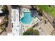 Aerial view of a community pool with lounge chairs and mature trees at 12215 S Potomac St, Phoenix, AZ 85044