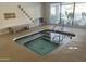 Inviting indoor spa featuring a raised jacuzzi with tile accents and serene views at 12215 S Potomac St, Phoenix, AZ 85044