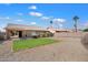 Backyard featuring a lawn, desert landscaping, block wall fencing, and a covered patio at 1301 N Jackson St, Chandler, AZ 85225